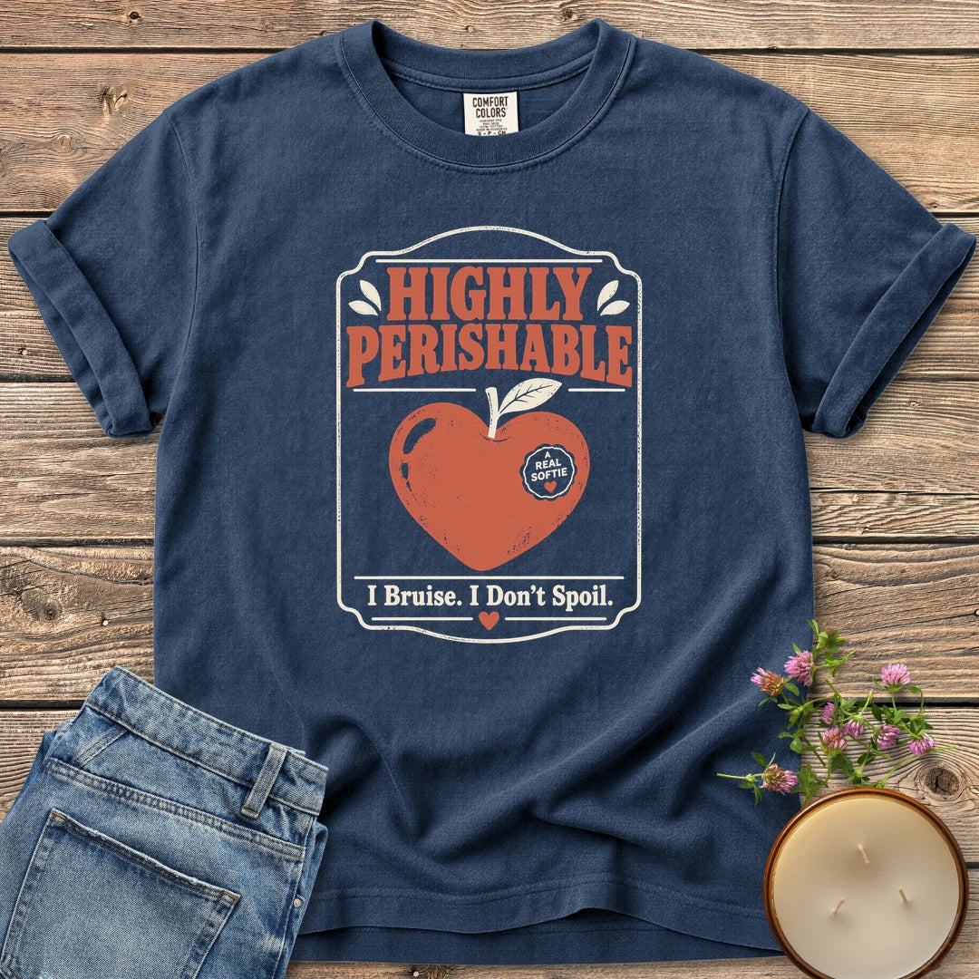 I Bruise I Don't Spoil t-shirt, a vintage label reading Highly Perishable with a heart-shaped apple and I Bruise. I Don't Spoil, on a Navy Comfort Colors tee