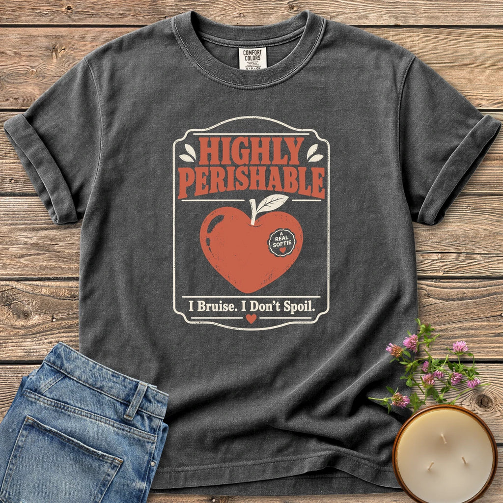 I Bruise I Don't Spoil t-shirt, a vintage label reading Highly Perishable with a heart-shaped apple and I Bruise. I Don't Spoil, on a Pepper Comfort Colors tee