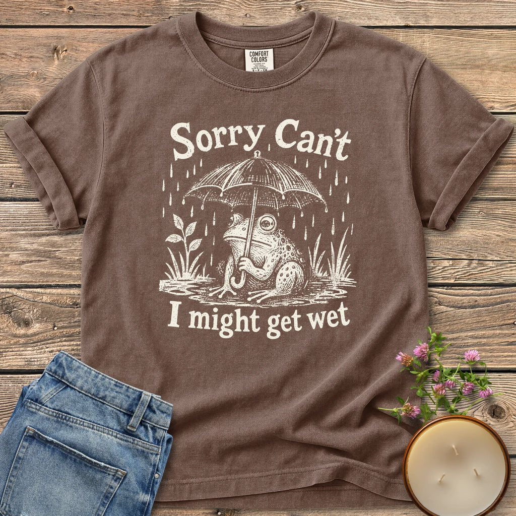 I Might Get Wet t-shirt, a frog under an umbrella in the rain between Sorry Can't and I might get wet, on an Espresso Comfort Colors tee