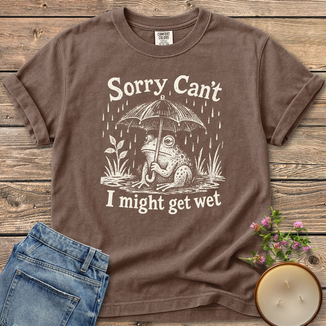 I Might Get Wet t-shirt, a frog under an umbrella in the rain between Sorry Can't and I might get wet, on an Espresso Comfort Colors tee