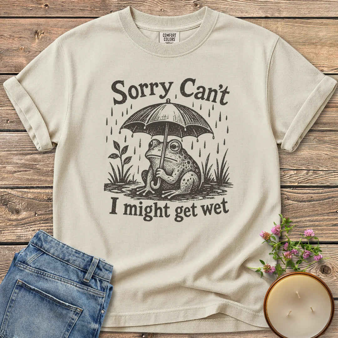 I Might Get Wet t-shirt, a frog under an umbrella in the rain between Sorry Can't and I might get wet, on an Ivory Comfort Colors tee