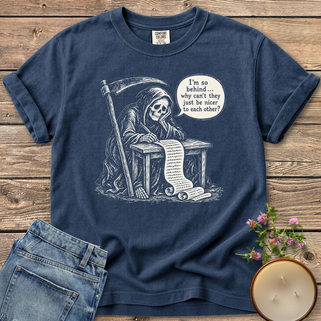 Just Be Nicer t-shirt, a grim reaper at a desk with a long list saying I'm so behind, why can't they just be nicer to each other?, on a Navy Comfort Colors tee