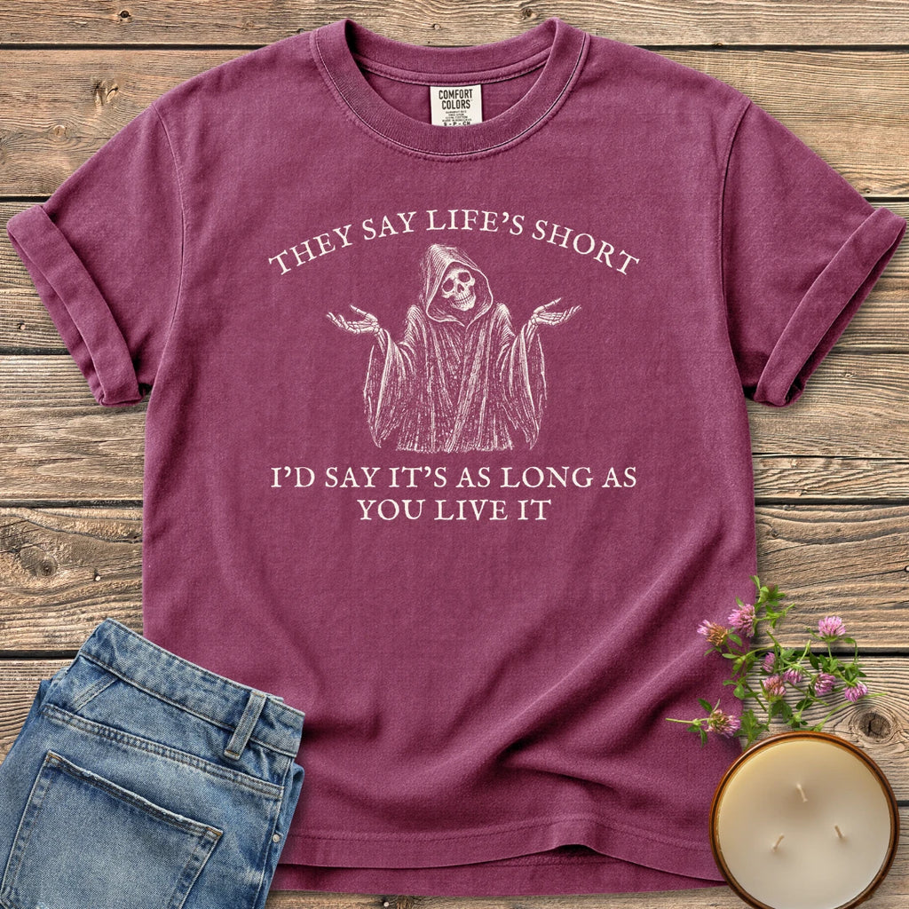 Long As You Live It t-shirt, a shrugging grim reaper between They Say Life's Short and I'd Say It's As Long As You Live It, on a Berry Comfort Colors tee
