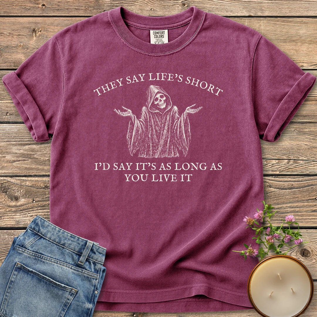 Long As You Live It t-shirt, a shrugging grim reaper between They Say Life's Short and I'd Say It's As Long As You Live It, on a Berry Comfort Colors tee