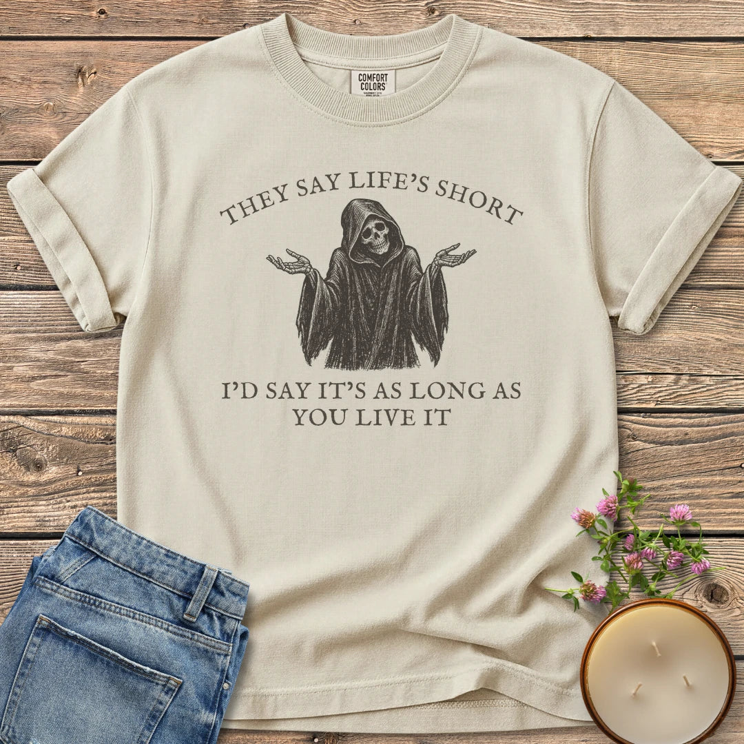 Long As You Live It t-shirt, a shrugging grim reaper between They Say Life's Short and I'd Say It's As Long As You Live It, on an Ivory Comfort Colors tee