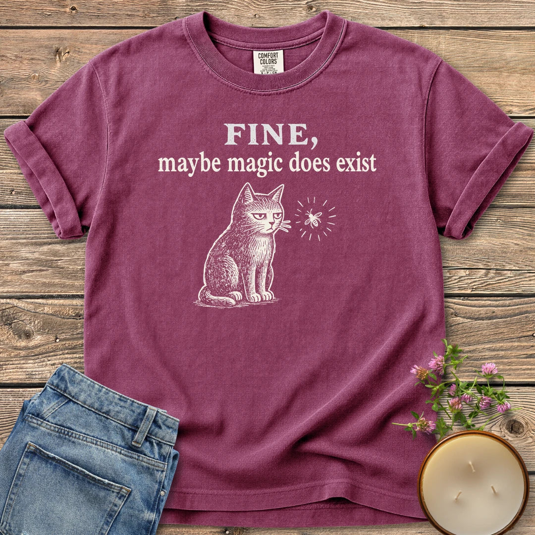 Maybe Magic Does Exist t-shirt, a grumpy cat watching a firefly under Fine, maybe magic does exist, on a Berry Comfort Colors tee