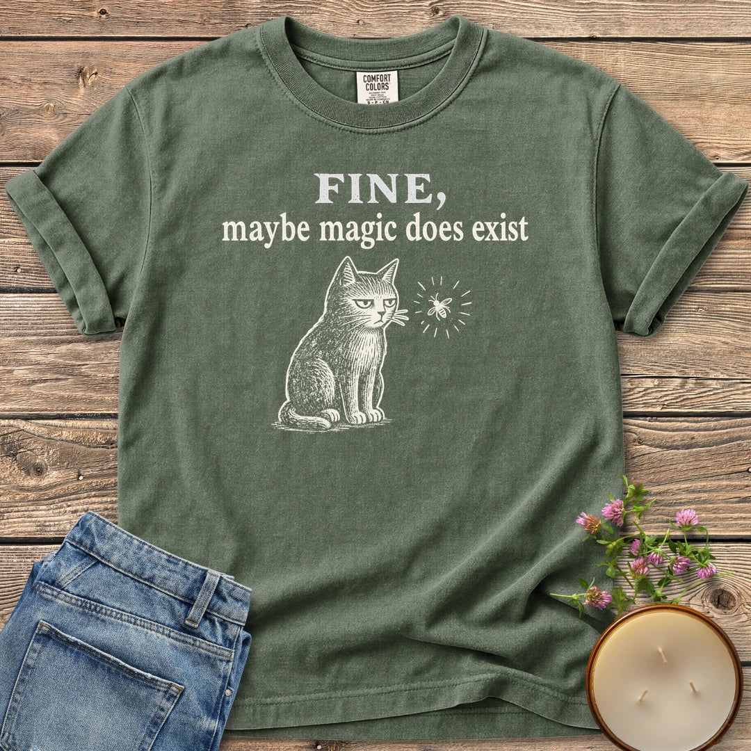 Maybe Magic Does Exist t-shirt, a grumpy cat watching a firefly under Fine, maybe magic does exist, on a Moss Comfort Colors tee