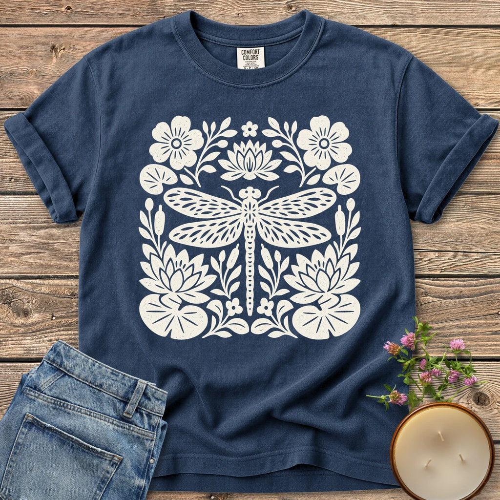 Meadow Dragonfly Folk Art Flat t-shirt, a folk art dragonfly surrounded by lily pads and flowers, on a Navy Comfort Colors tee
