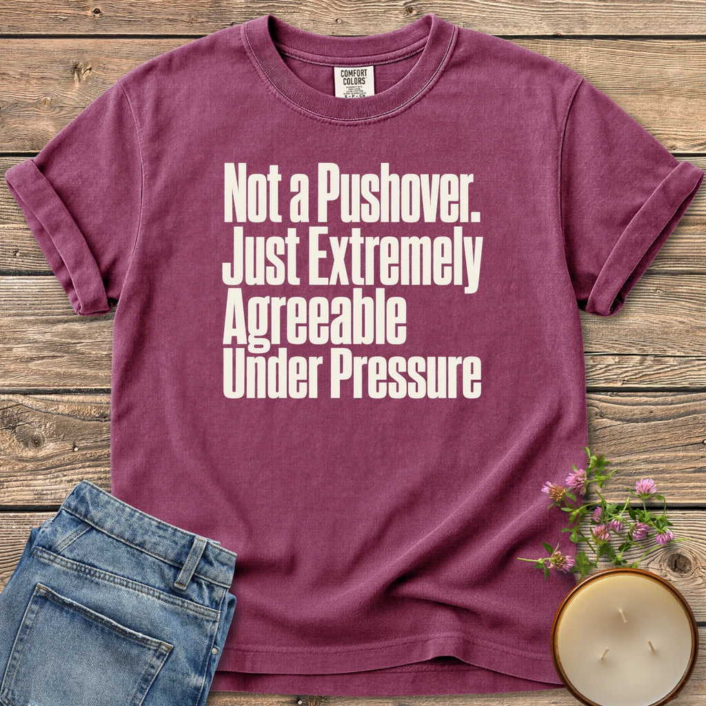 Not a Pushover t-shirt, Not a Pushover. Just Extremely Agreeable Under Pressure in bold condensed type, on a Berry Comfort Colors tee