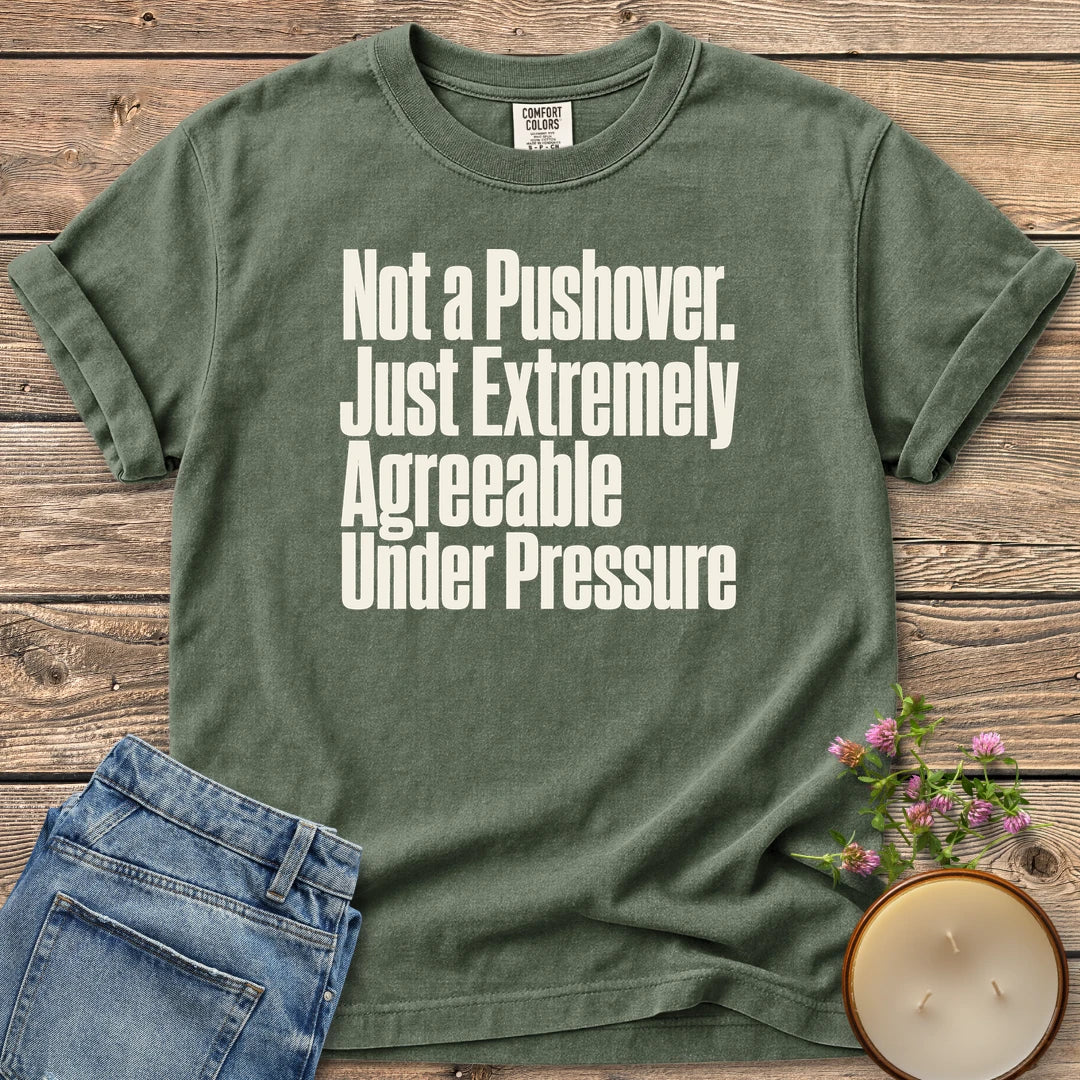 Not a Pushover t-shirt, Not a Pushover. Just Extremely Agreeable Under Pressure in bold condensed type, on a Moss Comfort Colors tee