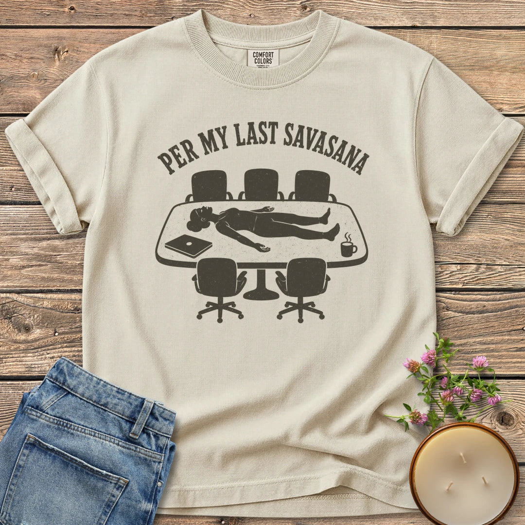Per My Last Savasana t-shirt, a person lying flat on a conference table under Per My Last Savasana, on an Ivory Comfort Colors tee
