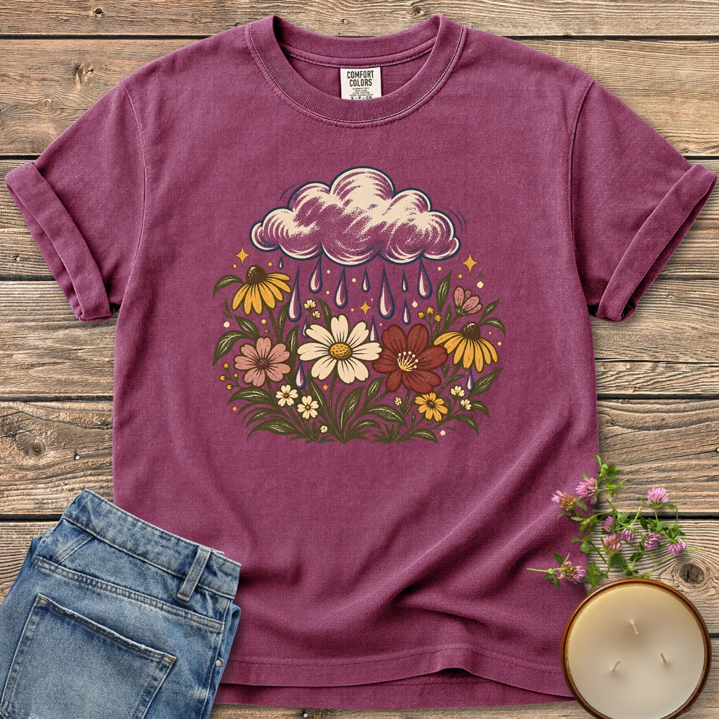 Rain Cloud Wildflower Meadow t-shirt, a rain cloud watering a colorful wildflower meadow, on a Berry Comfort Colors tee