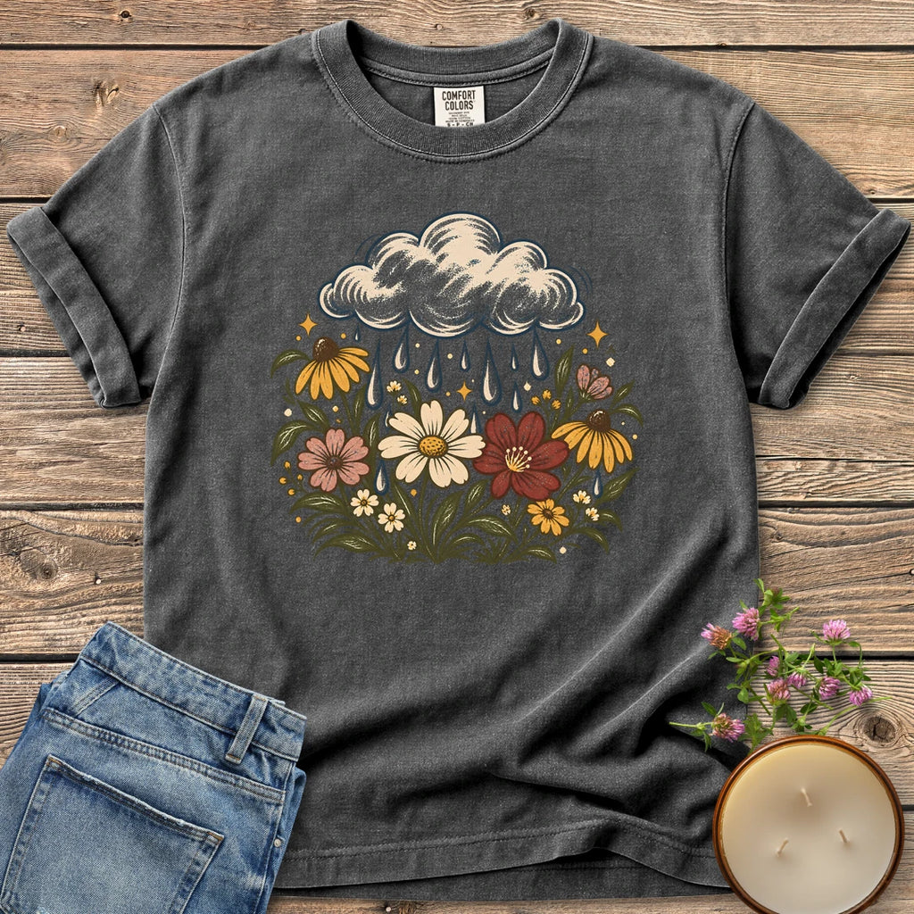 Rain Cloud Wildflower Meadow t-shirt, a rain cloud watering a colorful wildflower meadow, on a Pepper Comfort Colors tee