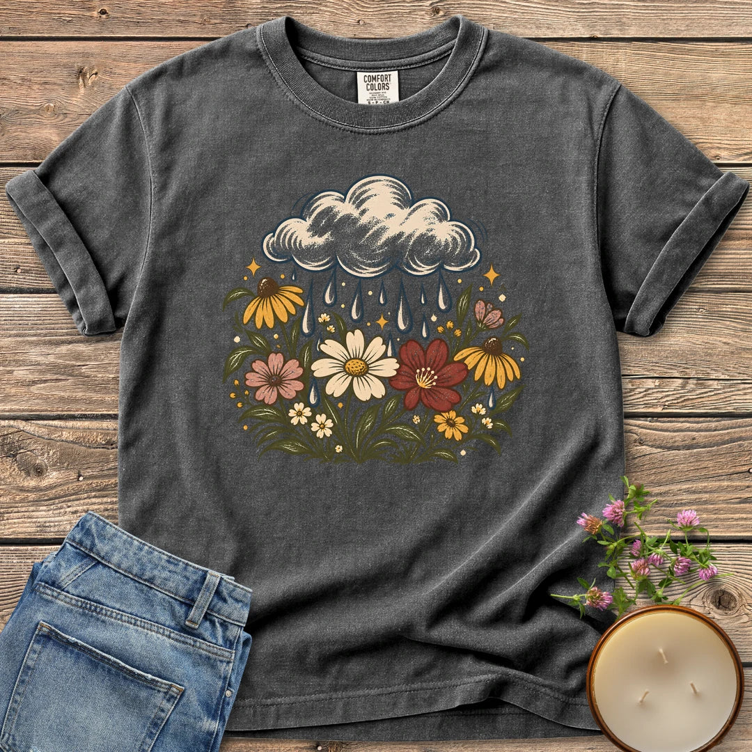 Rain Cloud Wildflower Meadow t-shirt, a rain cloud watering a colorful wildflower meadow, on a Pepper Comfort Colors tee