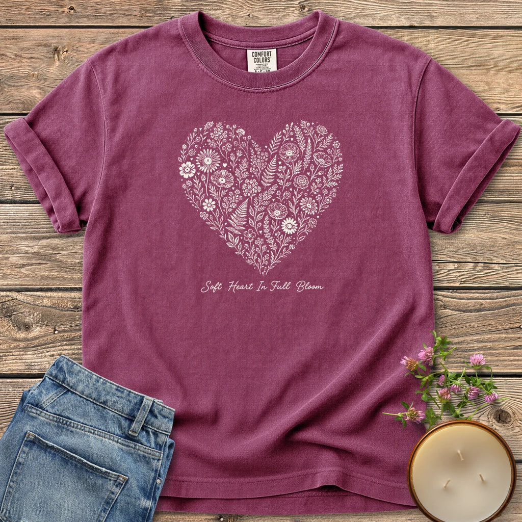 Soft Heart In Full Bloom t-shirt, a heart filled with wildflowers and ferns above Soft Heart In Full Bloom, on a Berry Comfort Colors tee