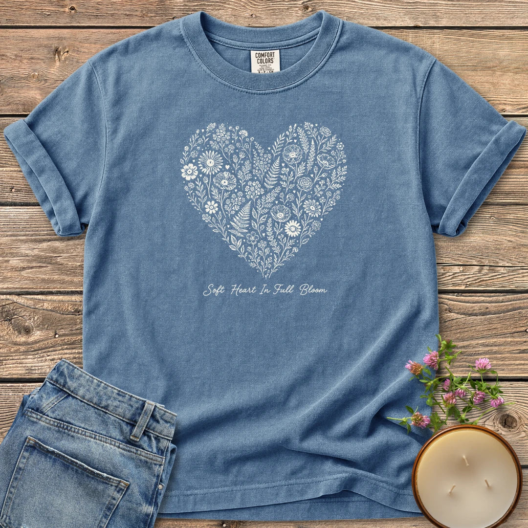 Soft Heart In Full Bloom t-shirt, a heart filled with wildflowers and ferns above Soft Heart In Full Bloom, on a Blue Jean Comfort Colors tee