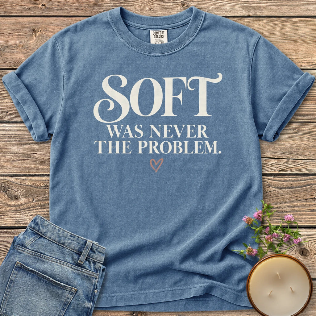 Soft Was Never The Problem t-shirt, Soft Was Never The Problem in bold vintage serif with a small heart, on a Blue Jean Comfort Colors tee