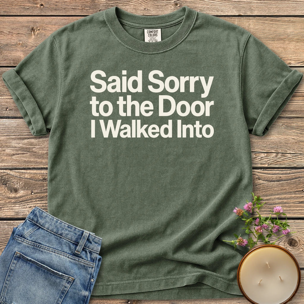 Sorry to the Door t-shirt, Said Sorry to the Door I Walked Into in bold sans type, on a Moss Comfort Colors tee