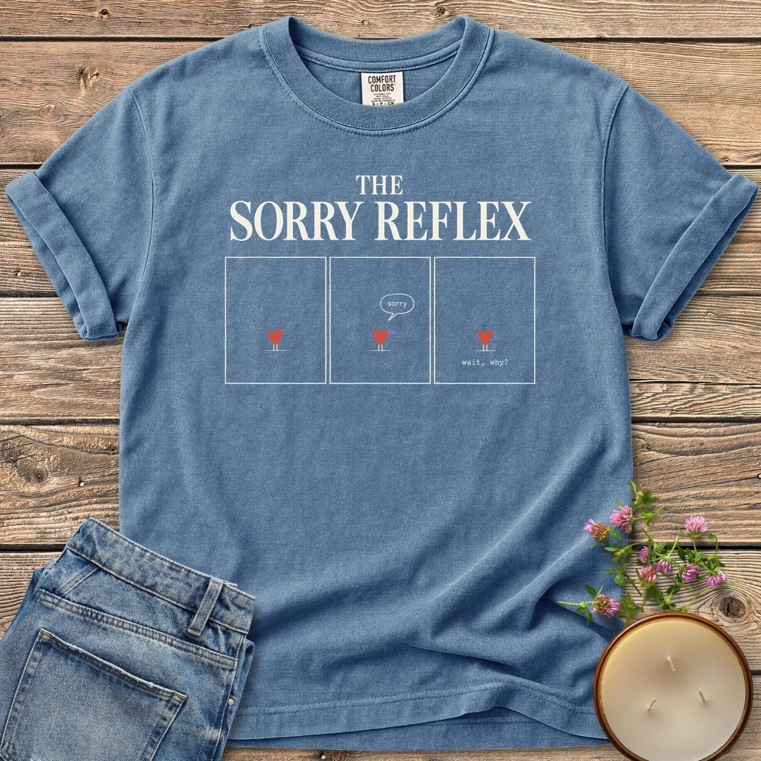 The Sorry Reflex t-shirt, The Sorry Reflex as three comic panels of a small heart saying sorry then wait, why?, on a Blue Jean Comfort Colors tee