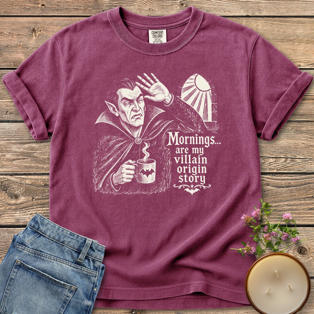 Villain Origin Story t-shirt, a vampire shielding his eyes from sunlight holding a coffee mug with Mornings... are my villain origin story, on a Berry Comfort Colors tee