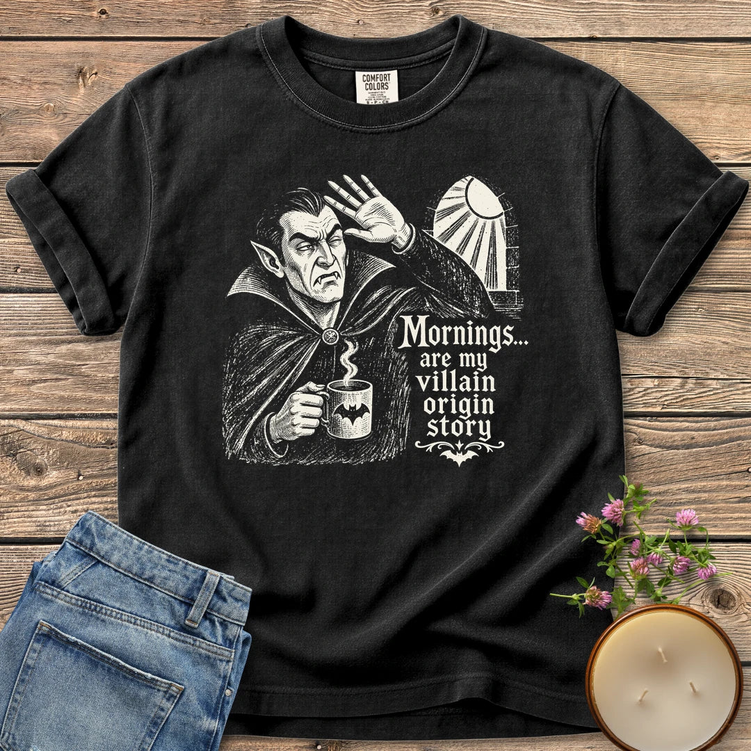 Villain Origin Story t-shirt, a vampire shielding his eyes from sunlight holding a coffee mug with Mornings... are my villain origin story, on a Black Comfort Colors tee