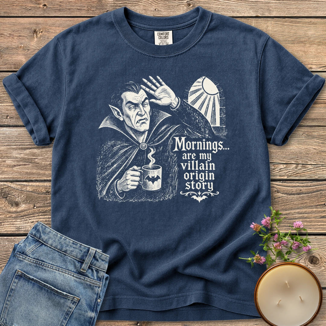Villain Origin Story t-shirt, a vampire shielding his eyes from sunlight holding a coffee mug with Mornings... are my villain origin story, on a Navy Comfort Colors tee