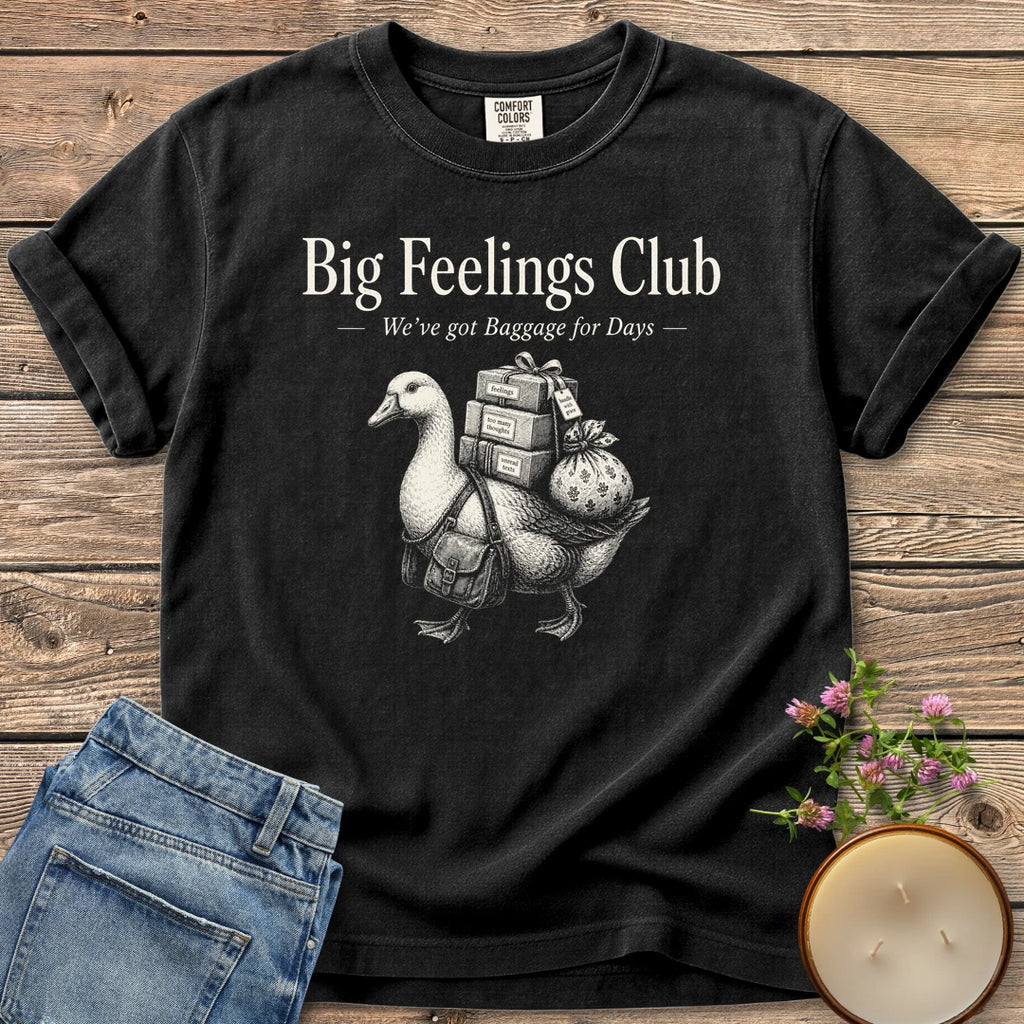 We've Got Baggage for Days t-shirt, a goose carrying boxes of feelings, too many thoughts and unread texts under Big Feelings Club, We've got Baggage for Days, on a Black Comfort Colors tee