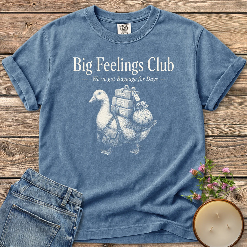 We've Got Baggage for Days t-shirt, a goose carrying boxes of feelings, too many thoughts and unread texts under Big Feelings Club, We've got Baggage for Days, on a Blue Jean Comfort Colors tee