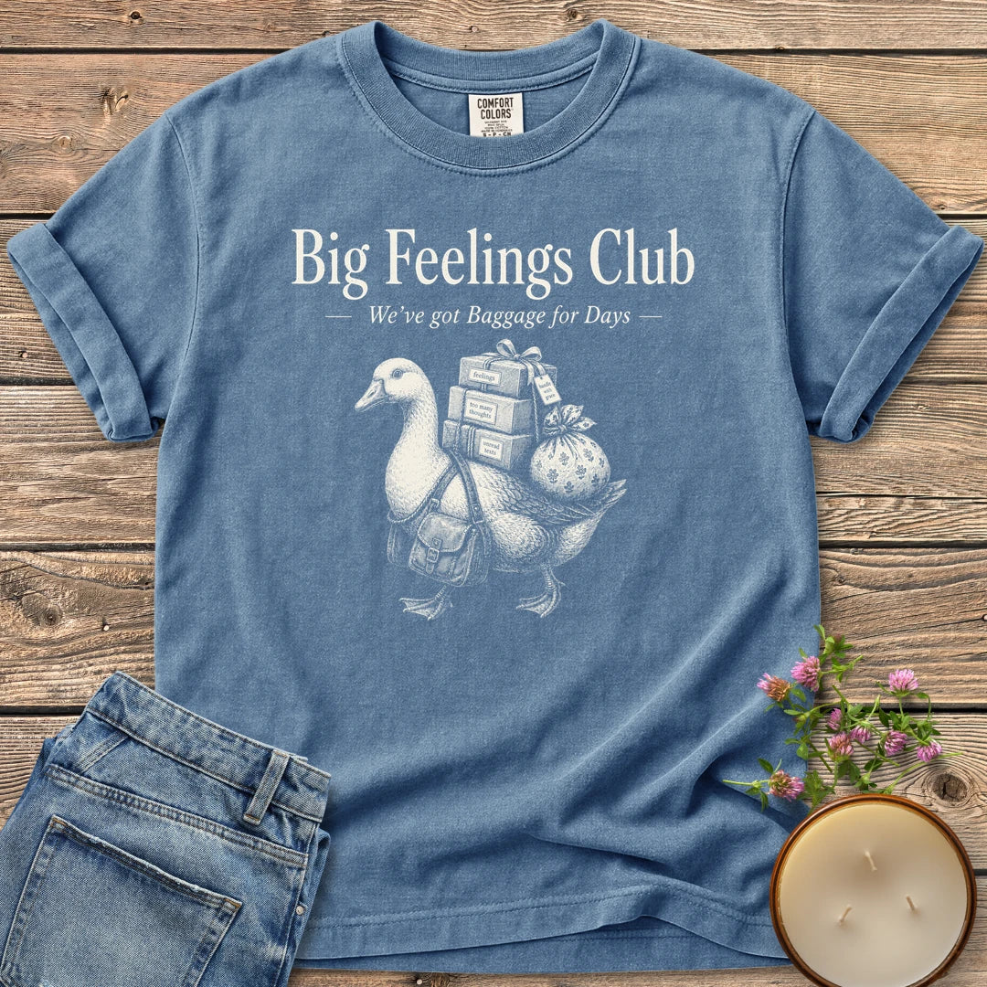 We've Got Baggage for Days t-shirt, a goose carrying boxes of feelings, too many thoughts and unread texts under Big Feelings Club, We've got Baggage for Days, on a Blue Jean Comfort Colors tee